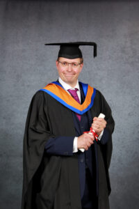 David Wheatley in his BSc graduation gown, colours and hat